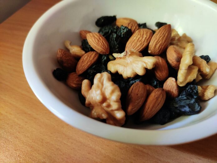 Photo by Pratik Bachhav brown and black nuts on white ceramic bowl