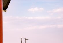고독사 예방 안전망 가동 A man standing in front of a building with a red door