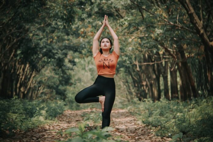 Photo by Yayan Sopian woman doing yoga near trees