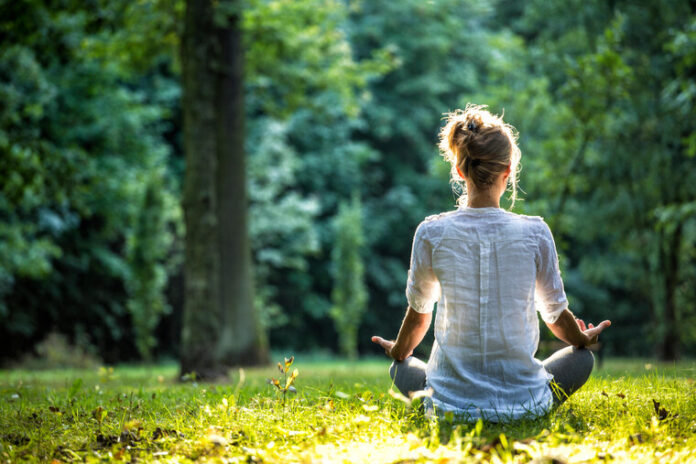 Young girl practicing joga and meditating